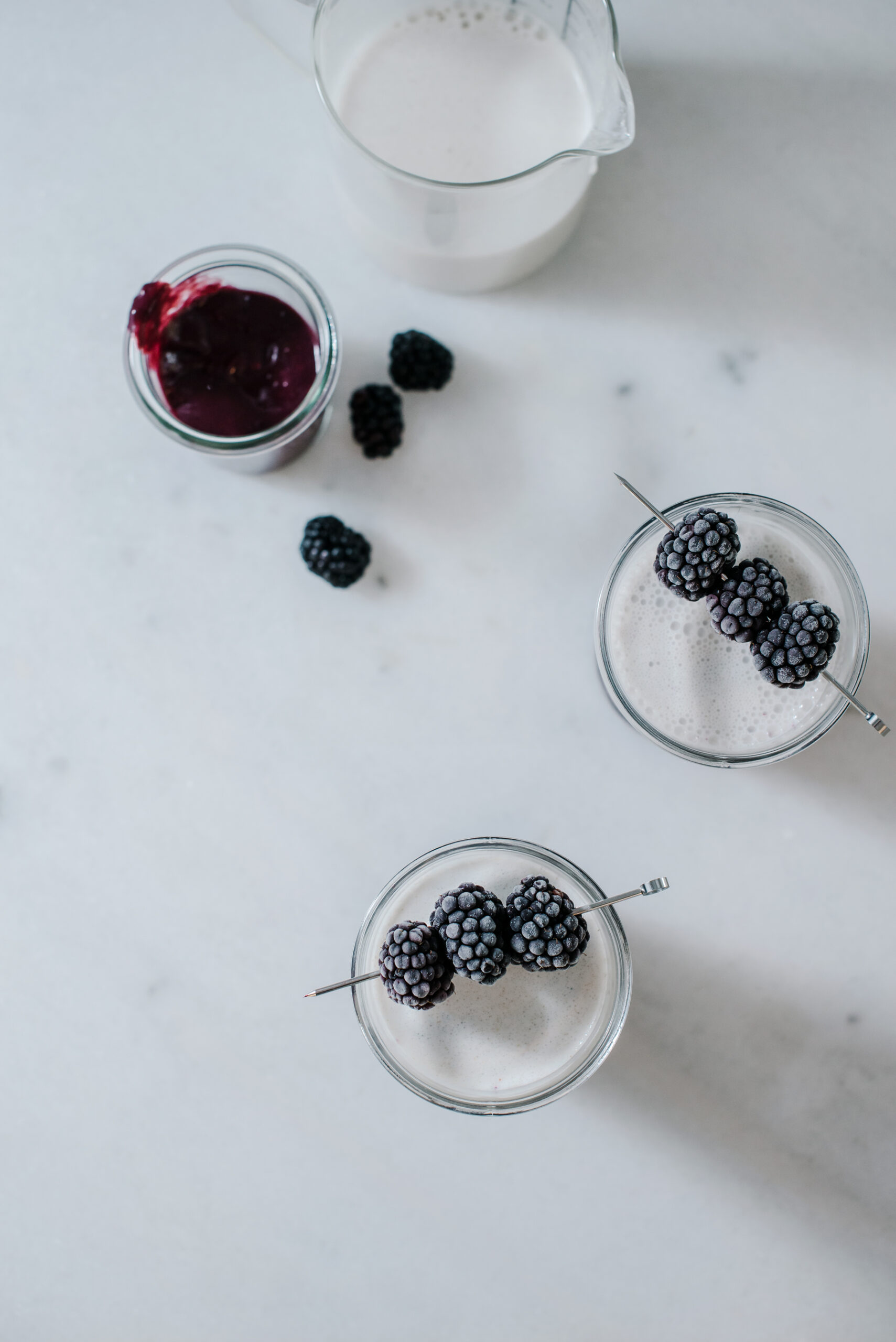 Glasses  of blackberry oat smoothie